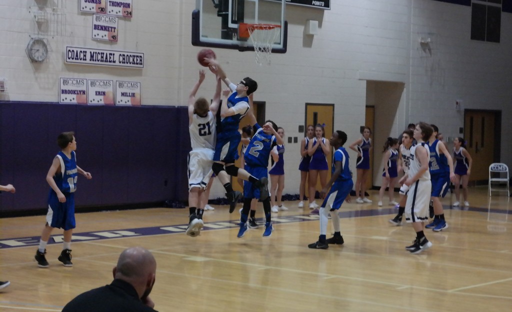 Seventh-grade Fannin Rebel Brady Martin denies Isaiah Hopper (21) a basket yesterday. Despite the block, the Rebels fell 37-29 to the Bobcats. (Photo by: Kevin Hensley)