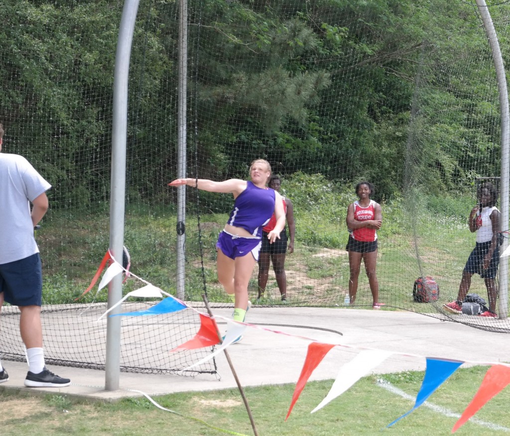 Lady Cats junior Raven Sparks launches the discus, during the competition at the AAAA Sectionals at Carrollton High School last Saturday. Sparks broke the Gilmer Lady Cats school record in the event with a toss of 105' 11", qualifying for state in the process. (Photo by: Kevin Hensley)