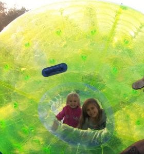 2nd grade WFES student Alyssa and Headstart student Lilly embark on a water wheel float across the pool.