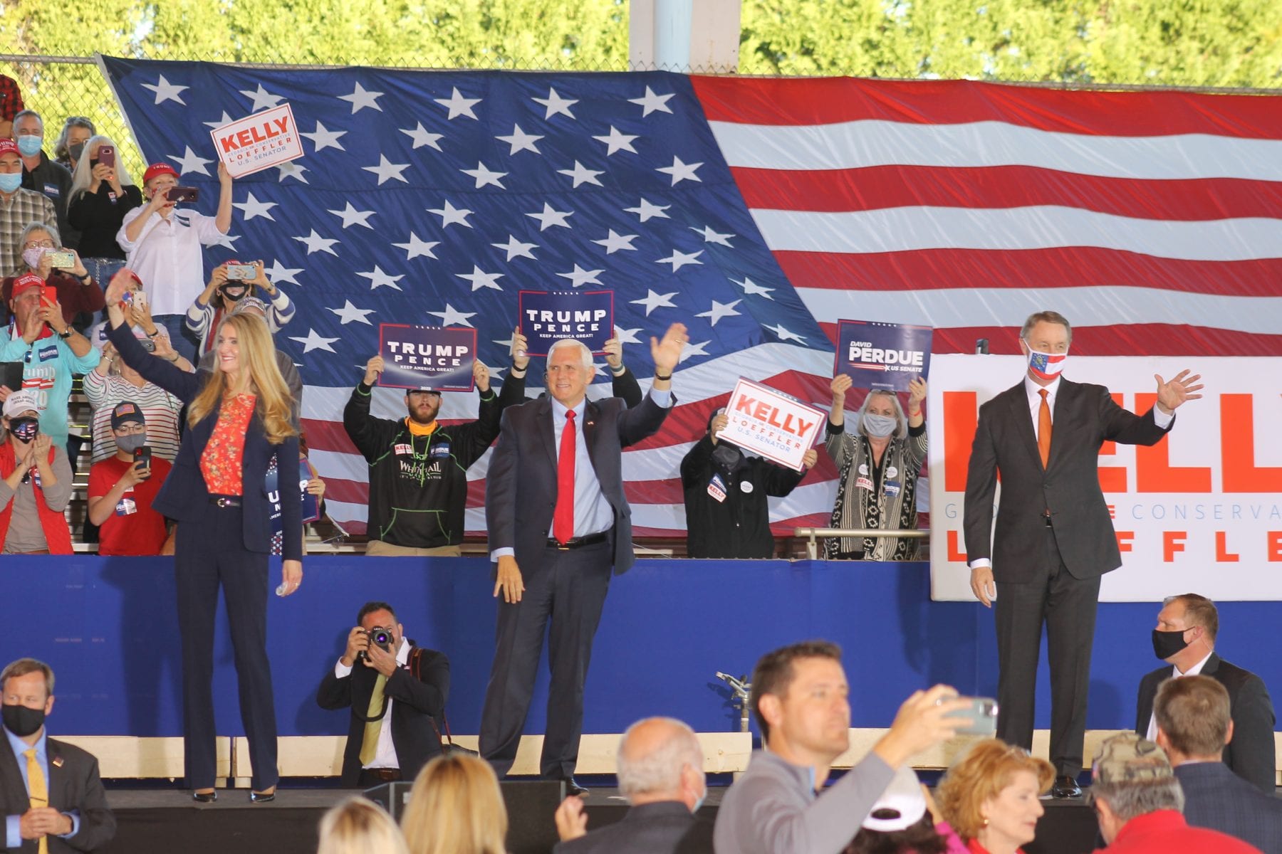 (left to right) Kelly Loeffler, Mike Pence and David Perdue engage with Georgia crowd at rally